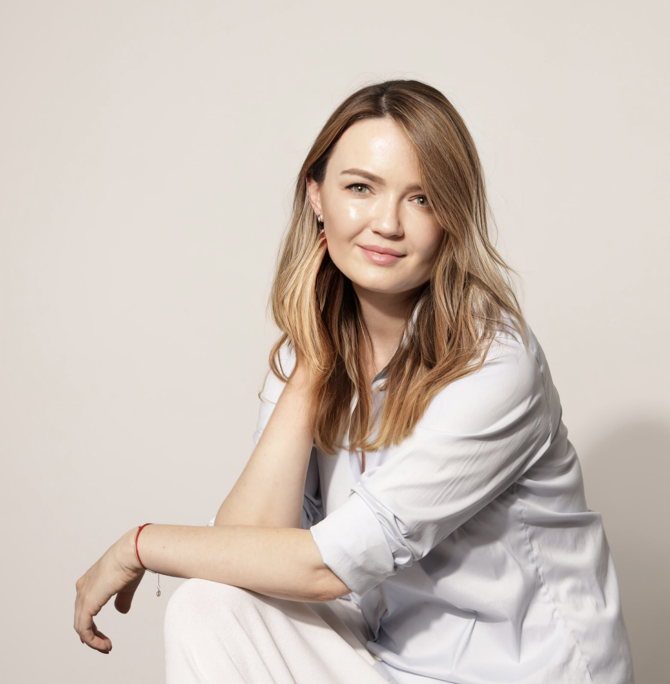 A woman posing on a light-color background.